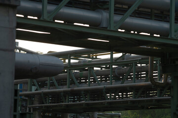 Imagine a bridge that showcases an extensive arrangement of various pipes stretching over it,...
