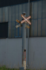 A prominent railroad crossing sign can be seen mounted on a sturdy pole that is strategically...