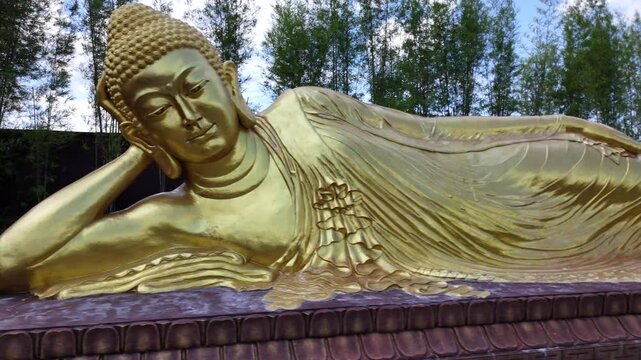 B-roll footage of Maha Vihara Mojopahit temple in East Java, featuring its grand architecture, Buddhist statues, serene courtyards, and spiritual atmosphere surrounded by lush tropical greenery.
