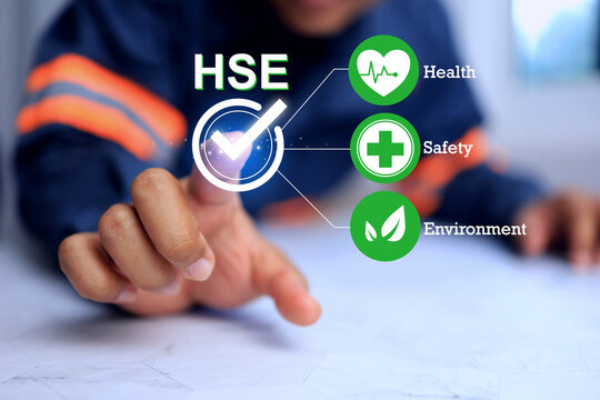 health safety environment concept with a safety staff pointing on checkmark to manage the work place to complied and meet safety regulation requirement and life quality of staff in employment