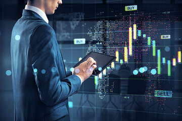 Businessman analyzing financial market charts on digital tablet against stock trading background...