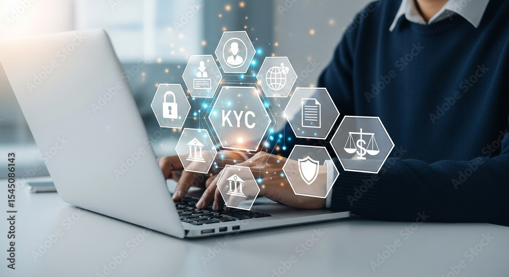Poster person typing on laptop with kyc and financial icons floating above the keyboard on a white desk