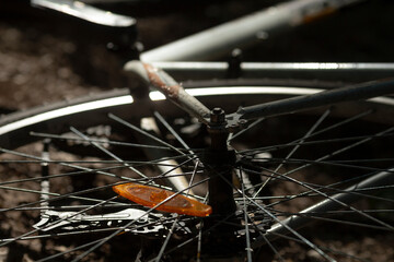 This image features a detailed closeup view of a bicycle wheel, prominently displaying its...