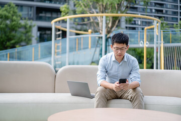 asian businessman working on smart phone
