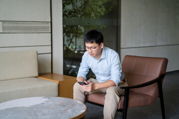 asian businessman working on smart phone