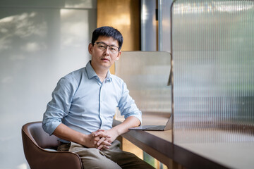 asian businessman sitting in office