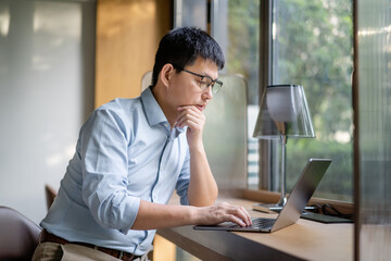 asian businessman working on laptop