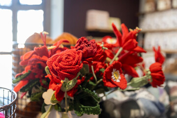 A Bouquet of Bright Red Knitted or Crocheted Flowers.
