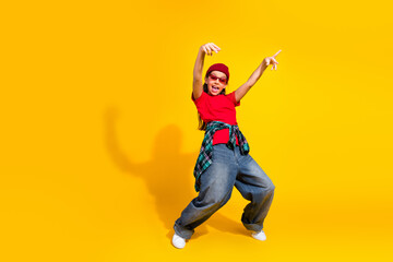 Cheerful young girl in casual attire expresses excitement with energetic gestures against a vibrant...
