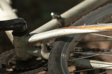 This is a closeup image of a wellmaintained bicycle, prominently featuring a fender attached to it...