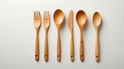 Shiny steel cutlery sets featuring a fork, spoon, and knife are isolated on a white background, ready for a meal
