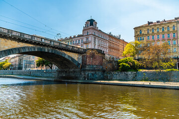 A view from the Vltava river towards the west bank passing under the Palacke bridge in Prague in...