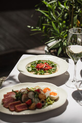 Restaurant terrace table served with gourmet salads and appetizer