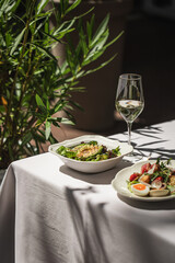Restaurant terrace table served with gourmet salads and appetizer