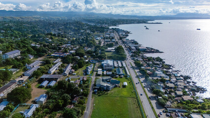 Aerial view of the harbour, main highway and national university campus in the foreground.