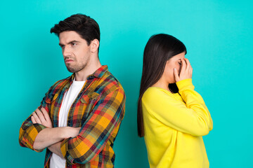 Young couple facing disagreement on a turquoise background, expressing emotions and highlighting...