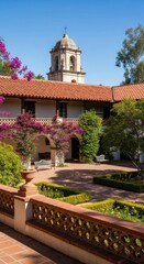 Naklejka premium Historic spanish courtyard with bell tower and lush gardens in sunlight