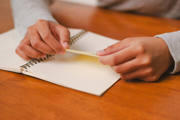 Creative writing session hands holding paper note cozy desk environment personal reflection indoor...