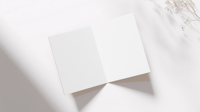 Open blank greeting card mockup with plant and shadow overlay on white background