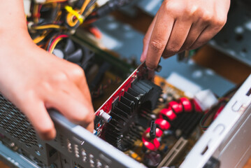Assembling a computer graphics card installation home workshop tutorial indoor close-up tech skills