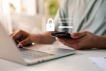 Hand of a man using mobile phone and laptop, secure access to user personal information, secure...
