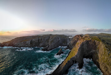 Stunning coastal cliffs at sunset, overlooking vast ocean with vibrant colors