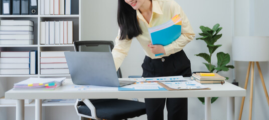 Smiling Woman Working at Desk with Laptop