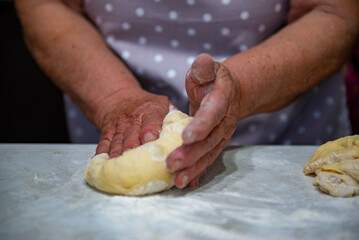 Granny baking buns in the kitchen. High quality photo