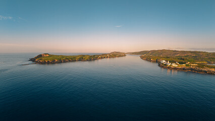 Obraz premium A Coastal Landscape, Beautiful Islands and Calm, Reflective Waters, Clear Sky