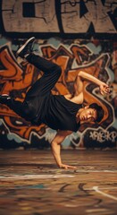 Young asian male breakdancer performing airflare in urban graffiti setting