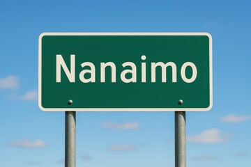 Green road sign reading "Nanaimo" stands clearly under a bright blue sky, marking direction or entry to the Canadian city.