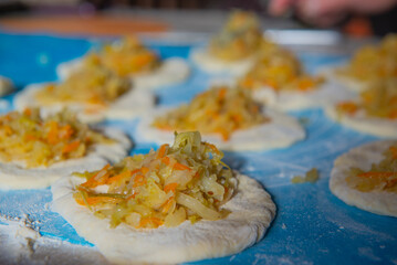 the dough for pies with cabbage is made by grandma. High quality photo