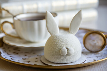 Spring on the table, Easter sweets in the form of rabbits and a porcelain cup, tea or coffee.