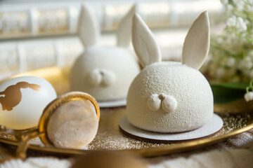 Spring on the table, Easter sweets in the form of rabbits and a porcelain cup, tea or coffee.