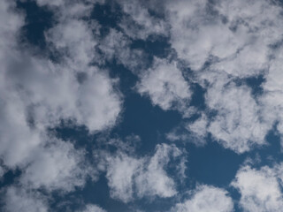 Bright Blue Sky with Scattered White Clouds and Sunlit Patch