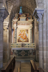Matera, Italy. Side altar with fresco of the Madonna and Child in the Church of San Giovanni Battista, Sassi of Matera. Decorated with angels, columns, and vivid details. Vertical image.