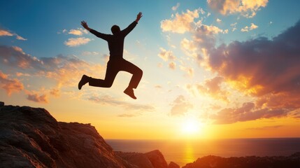 A silhouette of a person jumping in the air with a mountainous landscape and a sunset in the background.