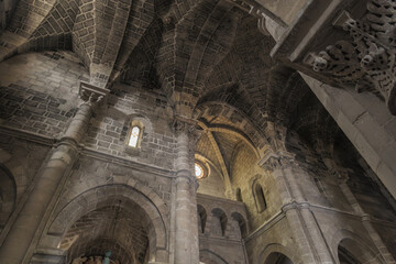 Matera, Italy. Vaulted ceiling and stone arches of the Church of San Giovanni Battista in the Sassi of Matera, Italy. Romanesque style with columns, capitals, and soft lighting. 