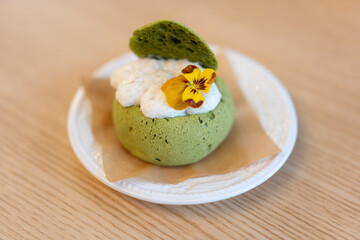 Close-up of matcha cake dessert in Asian Chinese bakery restaurant with warm colors