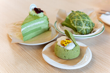 Close-up of matcha cake dessert in Asian Chinese bakery restaurant with warm colors