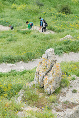 Matera, Italy. People hiking along path 406 descending to the Gravina river in the Murgia Materana Park, below the historic center of the Sassi di Matera, Italy. Vertical image.