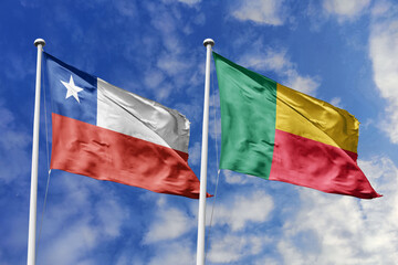 Flags of Chile and Benin Waving Together Against a Blue Sky, Symbolizing Diplomatic Relations and International Friendship