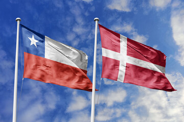 Flags of Chile and Denmark Waving Gracefully Against a Bright Blue Sky, Symbolizing Strong...