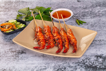 Grilled prawn skewer served sauce