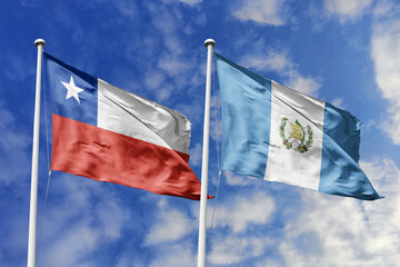 Flags of Chile and Guatemala Waving Side-by-Side Against a Bright Blue Sky, Representing Bilateral Ties and International Cooperation
