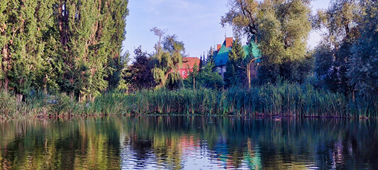 Jakabov palác (Jakab's palace) in Kosice. Lake in city park. Trees and reeds. View of the historic building in the center. Slovakia. Europe
