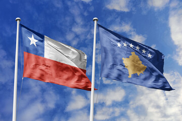 Flags of Chile and Kosovo Waving Together Under a Bright Blue Sky, Symbolizing International...
