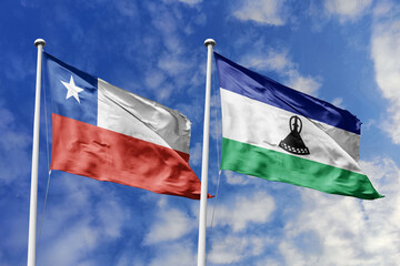 Flags of Chile and Lesotho Waving Together Under a Bright Blue Sky, Symbolizing International...