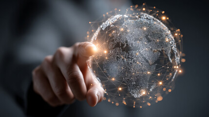 A person pointing at a digital globe with glowing connections in a dark background setting