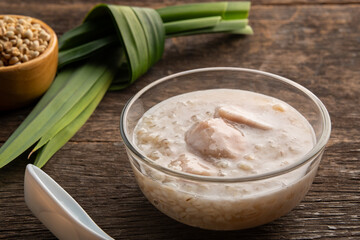 Thai sweet Job's Tears and taro pudding with a dash of coconut milk in glass bowl.thai dessert